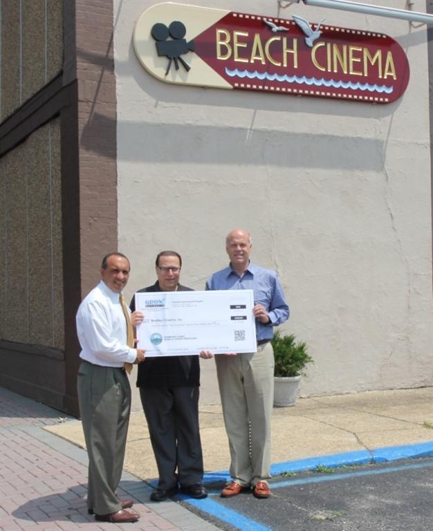 John Esposito (center), owner of Bradley Beach Cinema, accepts a Façade Improvement Program reimbursement check for $1,225 from Freeholder Thomas A. Arnone and Freeholder Deputy Director Gary J. Rich, Sr. on July 29, 2014 in Bradley Beach, NJ.